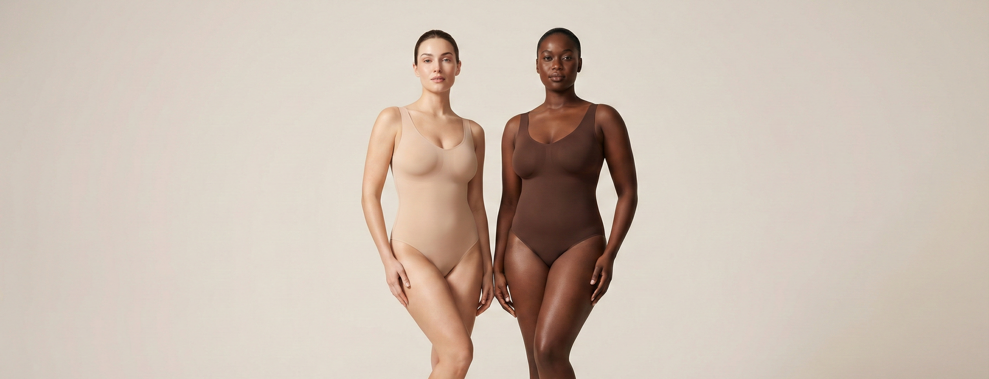Two women wearing beige and brown bodysuits on a plain background
